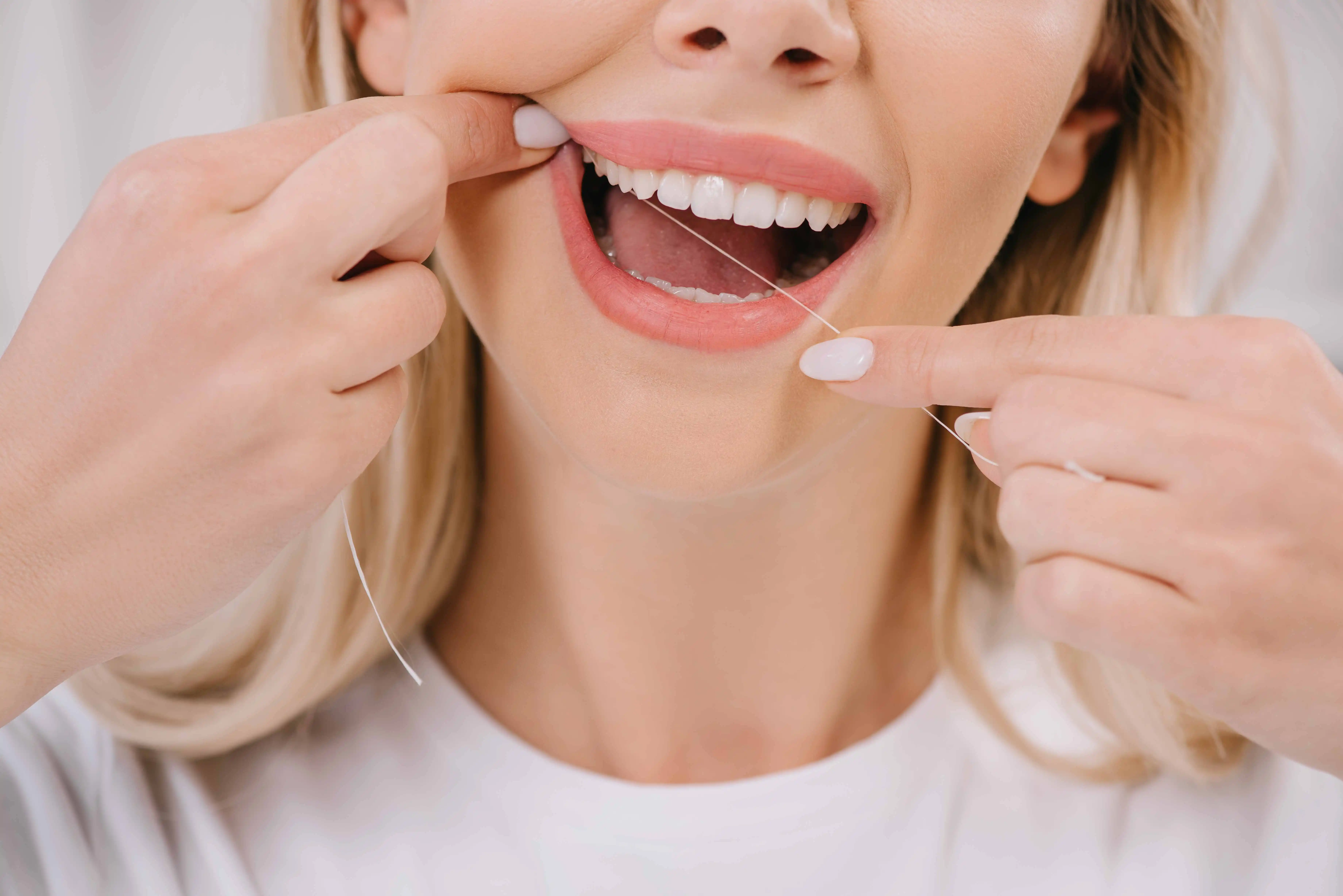 woman flossing teeth 